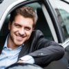 Portrait of an handsome guy driving his car